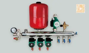 Un sistema di riscaldamento con separatore idraulico, serbatoio rosso, pompe verdi e manometro.