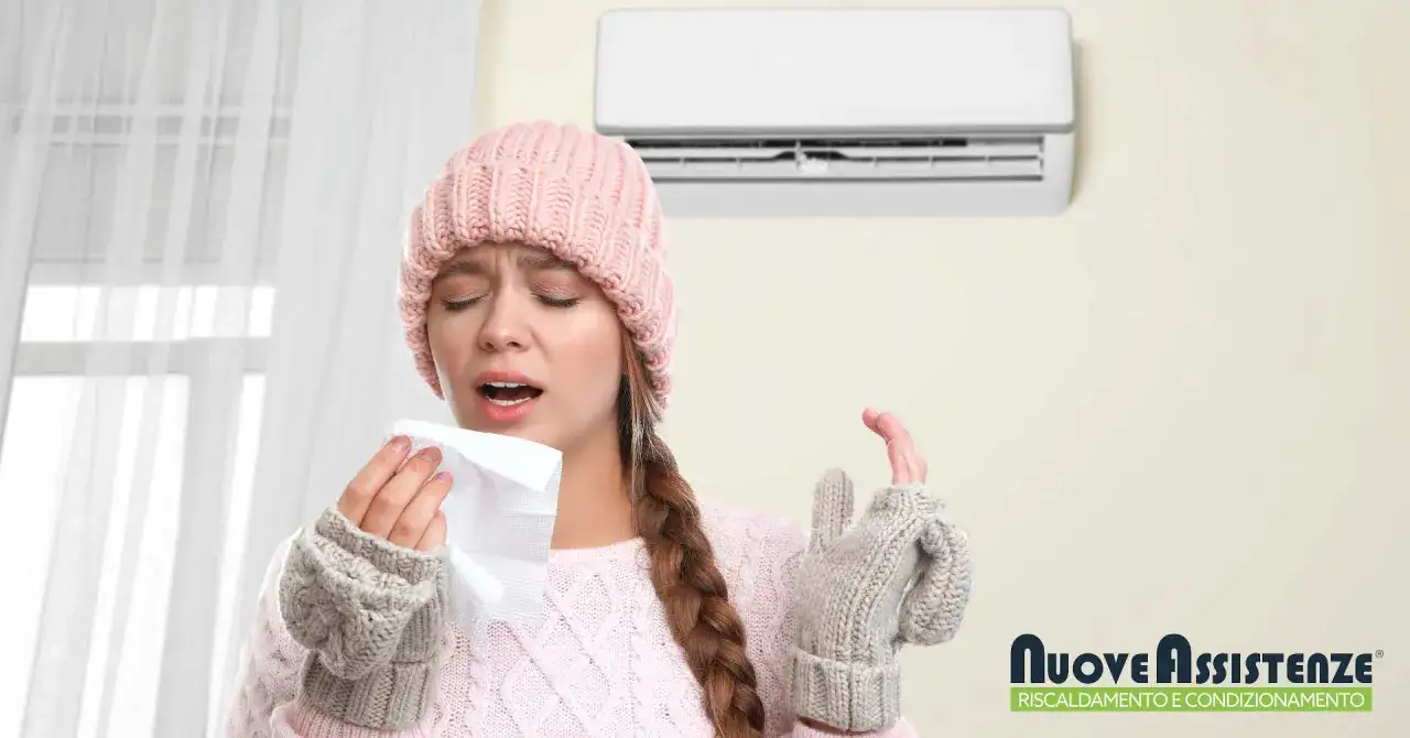 Donna con cappello e guanti, raffreddata, con fazzoletto. Il condizionatore non fa aria fredda, creando disagio.